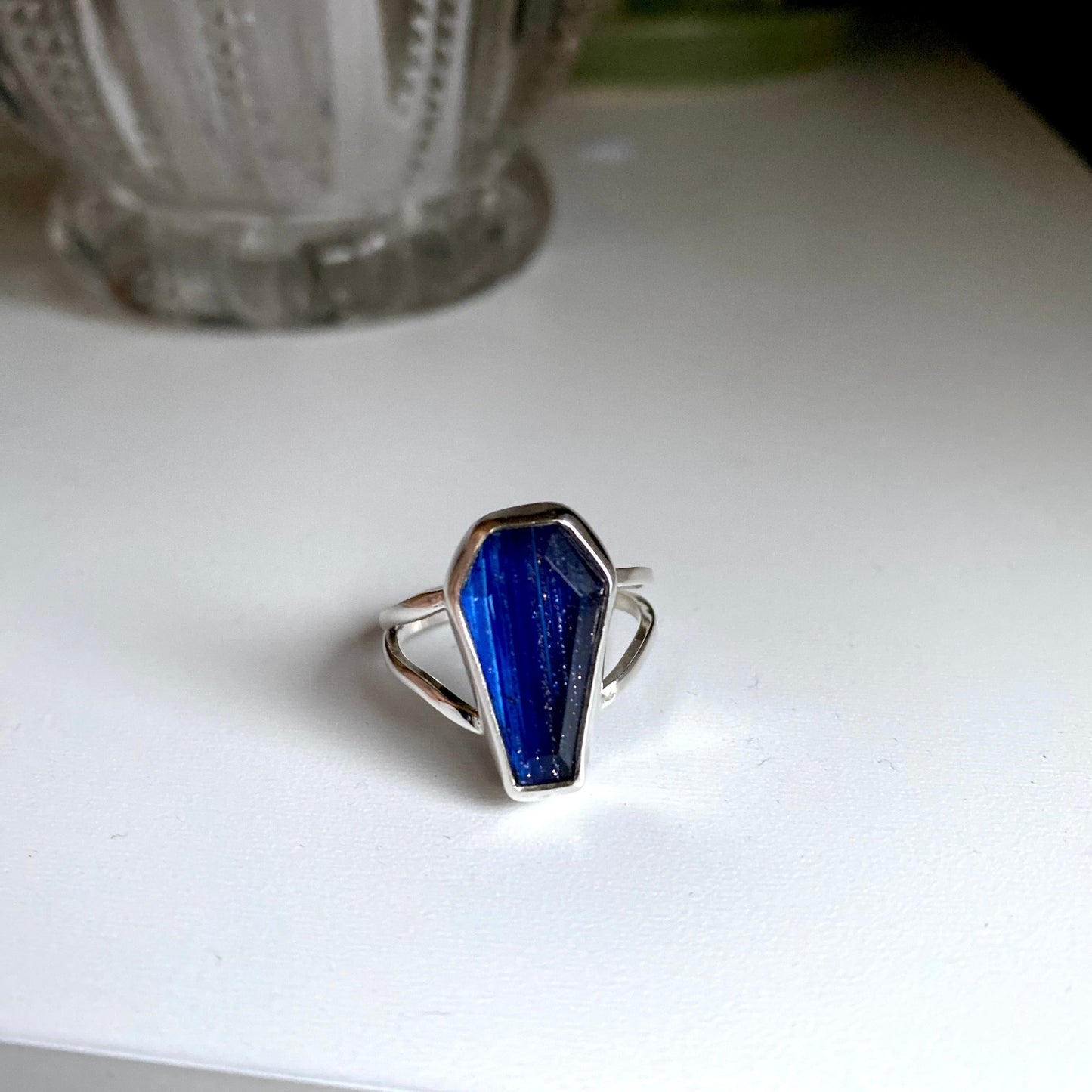 Blue coffin stone threaded with silver and gold through the stone. Split shank size 7 1/4