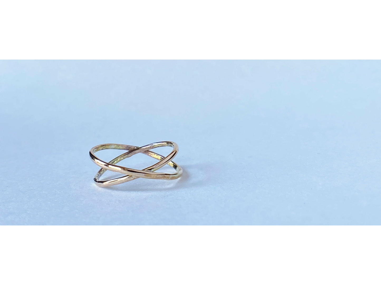 Two gold filled rings cross to make an x shape or a "twist"