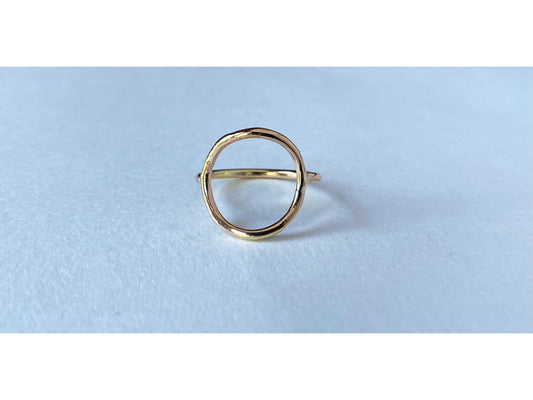 Circle ring in either silver or gold. Band meets the circle on the left and right size, open circle no back.