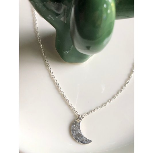 Simple silver chain with sterling silver cut moon mounted on the middle