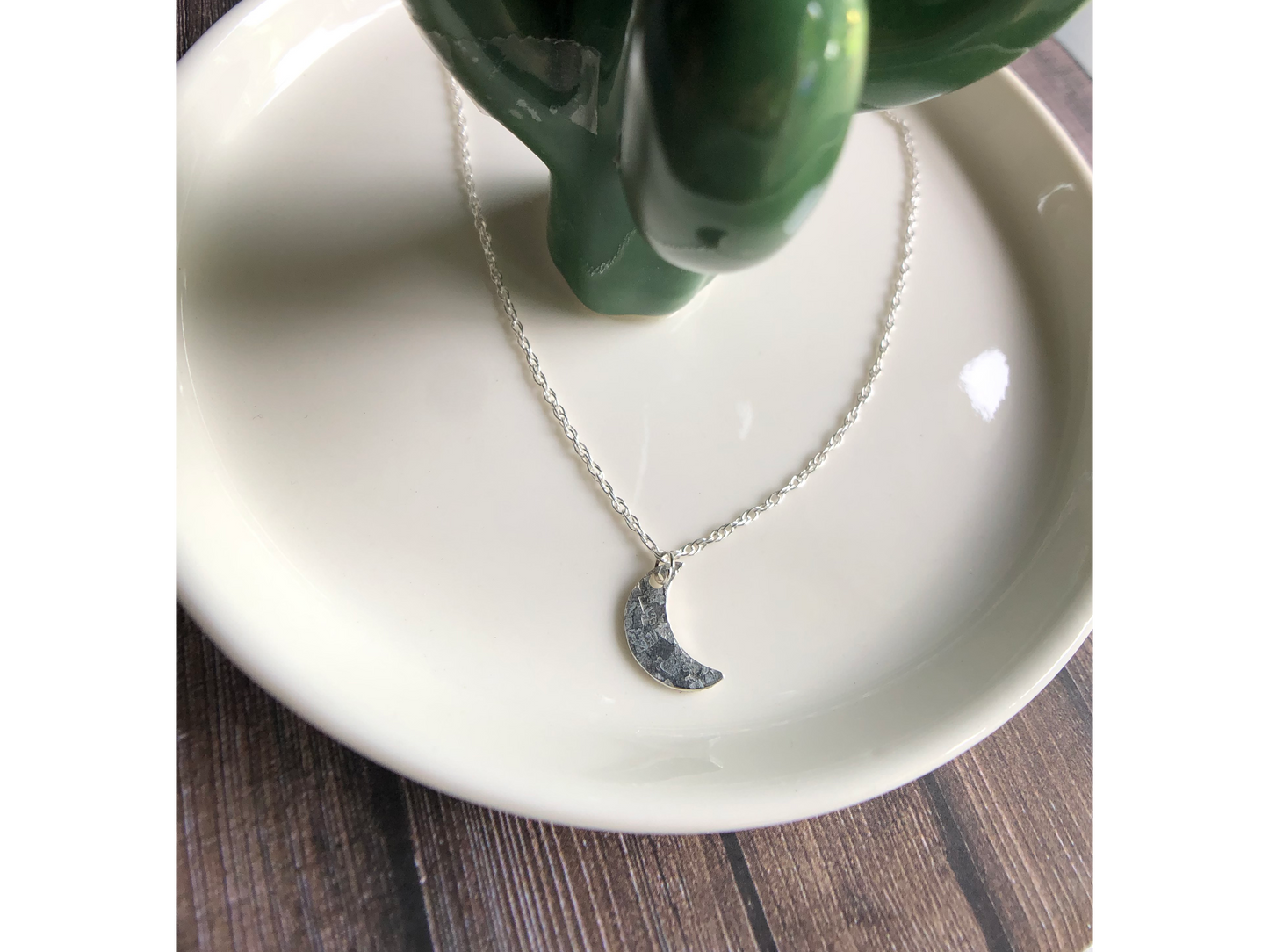 Simple silver chain with sterling silver cut moon mounted on the middle