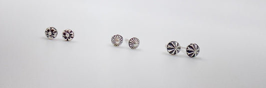 Small amethyst studs with closed back bezel.