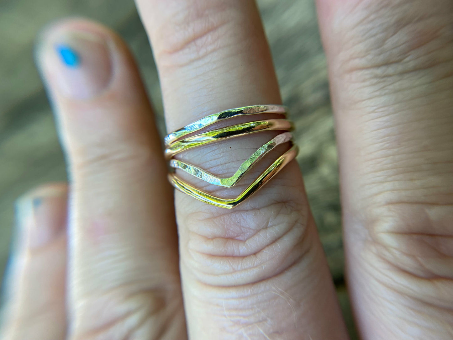 Silver and gold simple rings stacked upon a chevron shaped ring. Perfecting stacking set for a simple forward look.