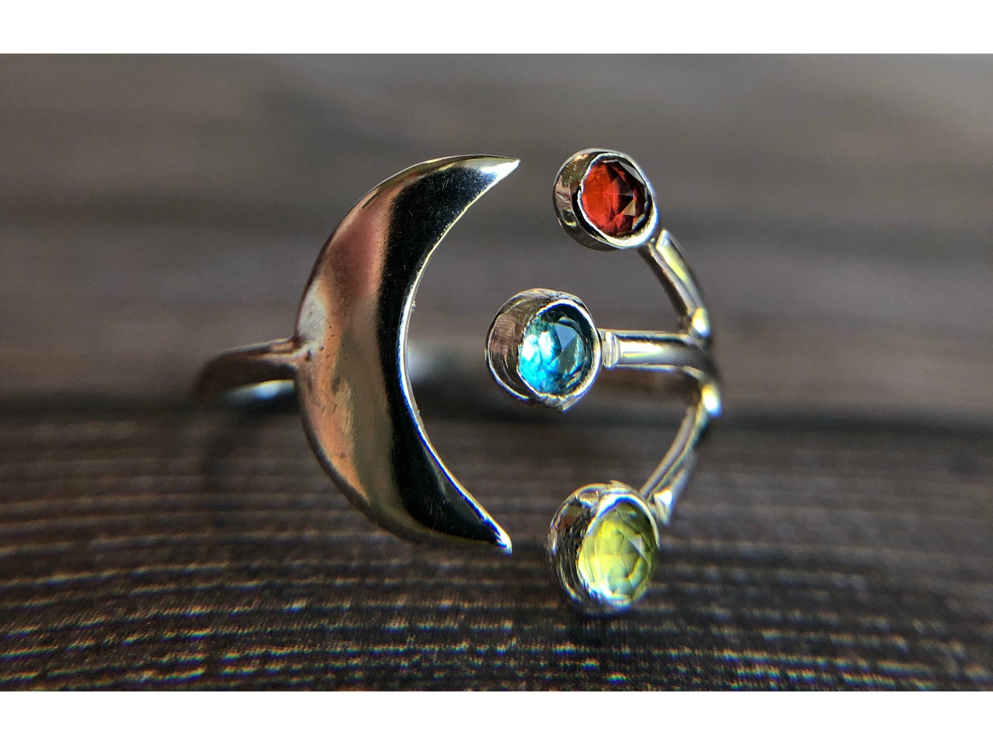 Adjustable ring with moon on one side and three stones of your choice on the opposite band.