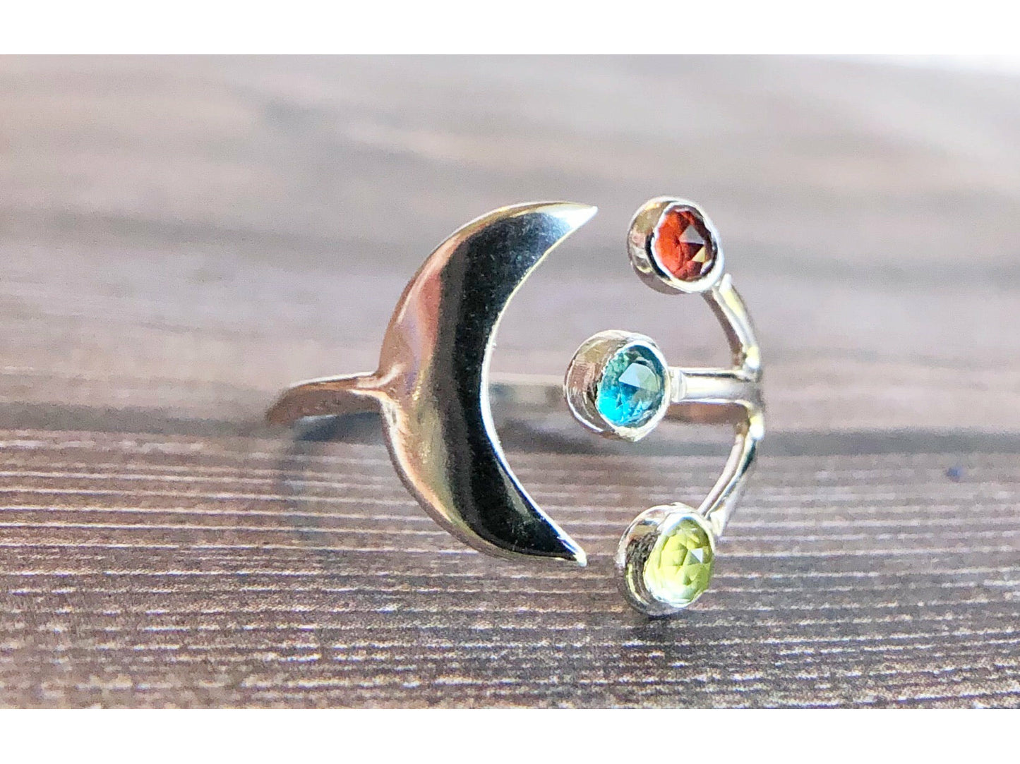 Adjustable ring with moon on one side and three stones of your choice on the opposite band.