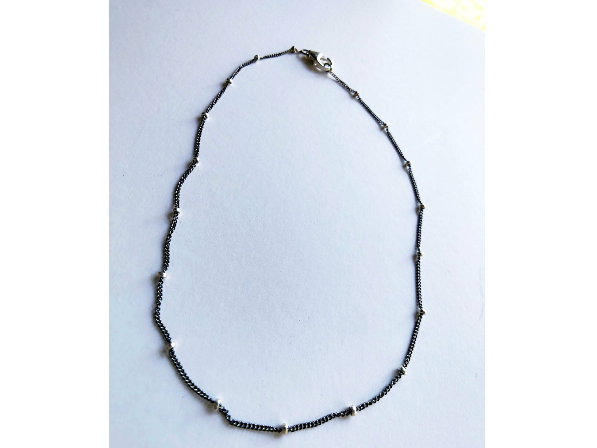 Small black bracelet with dots of silver.