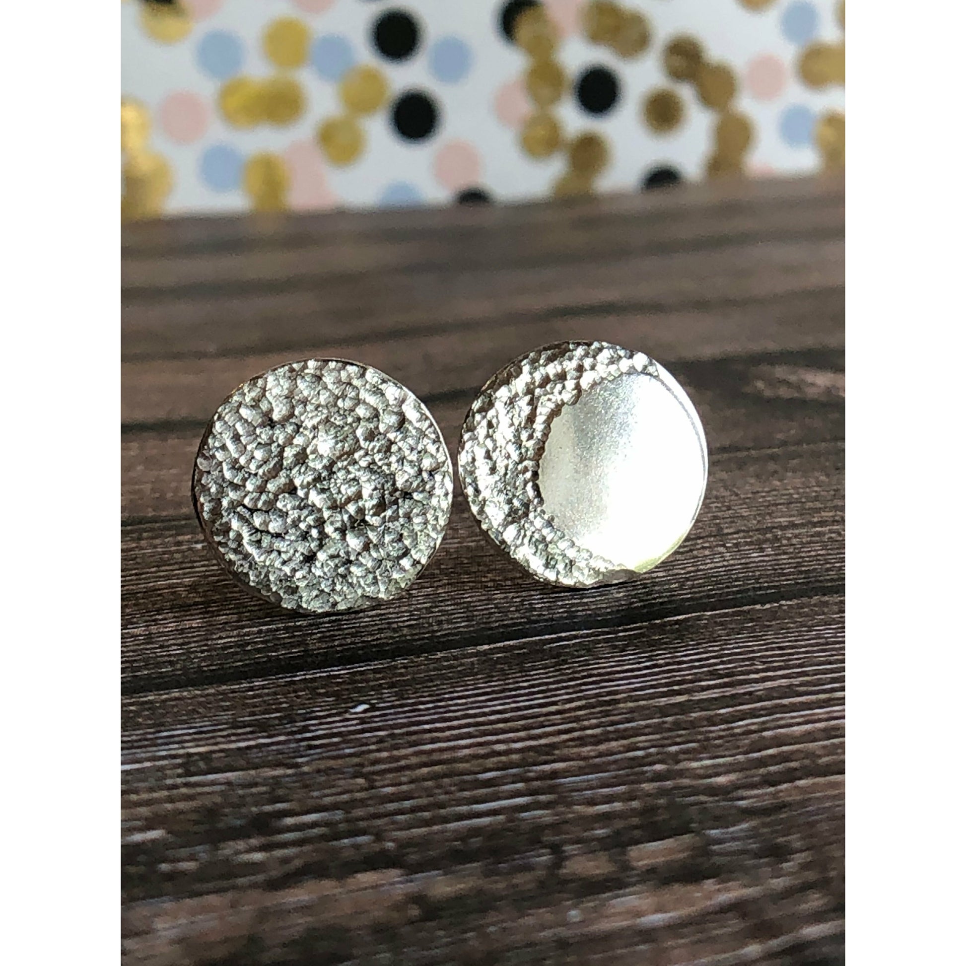 Circle pieces of silver with a crescent moon textured into each earrings. Center post