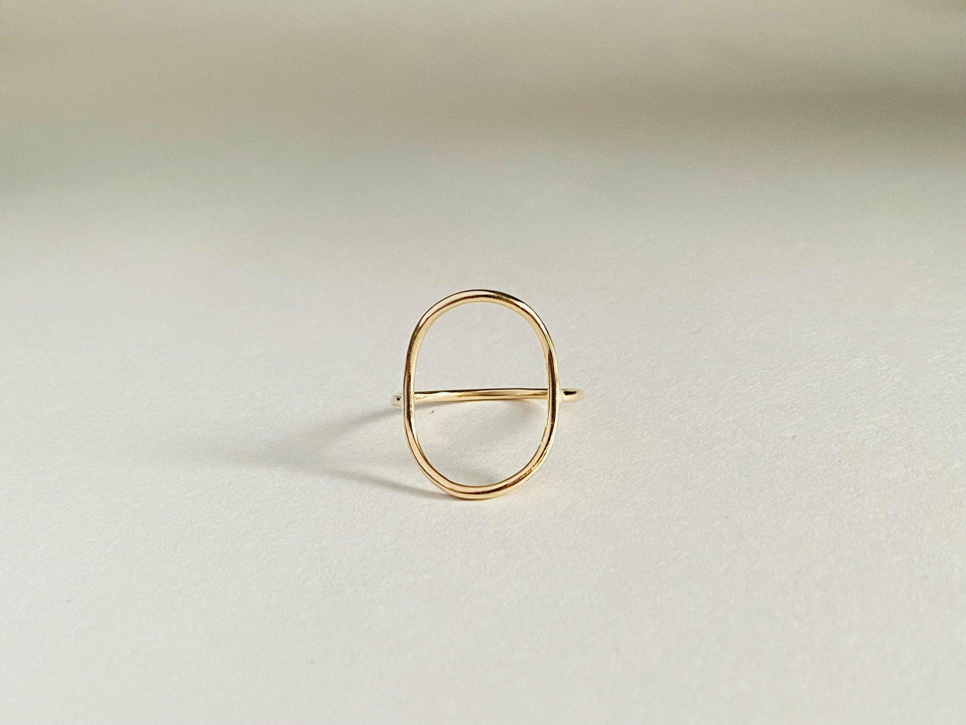 Gold filled oval ring with band attaching to either side of oval