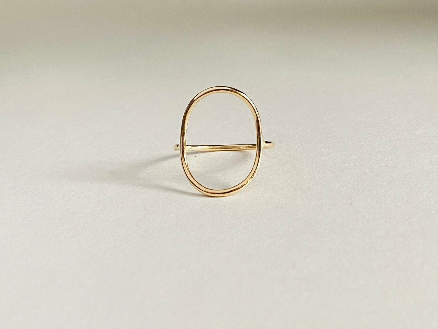 Gold filled oval ring with band attaching to either side of oval