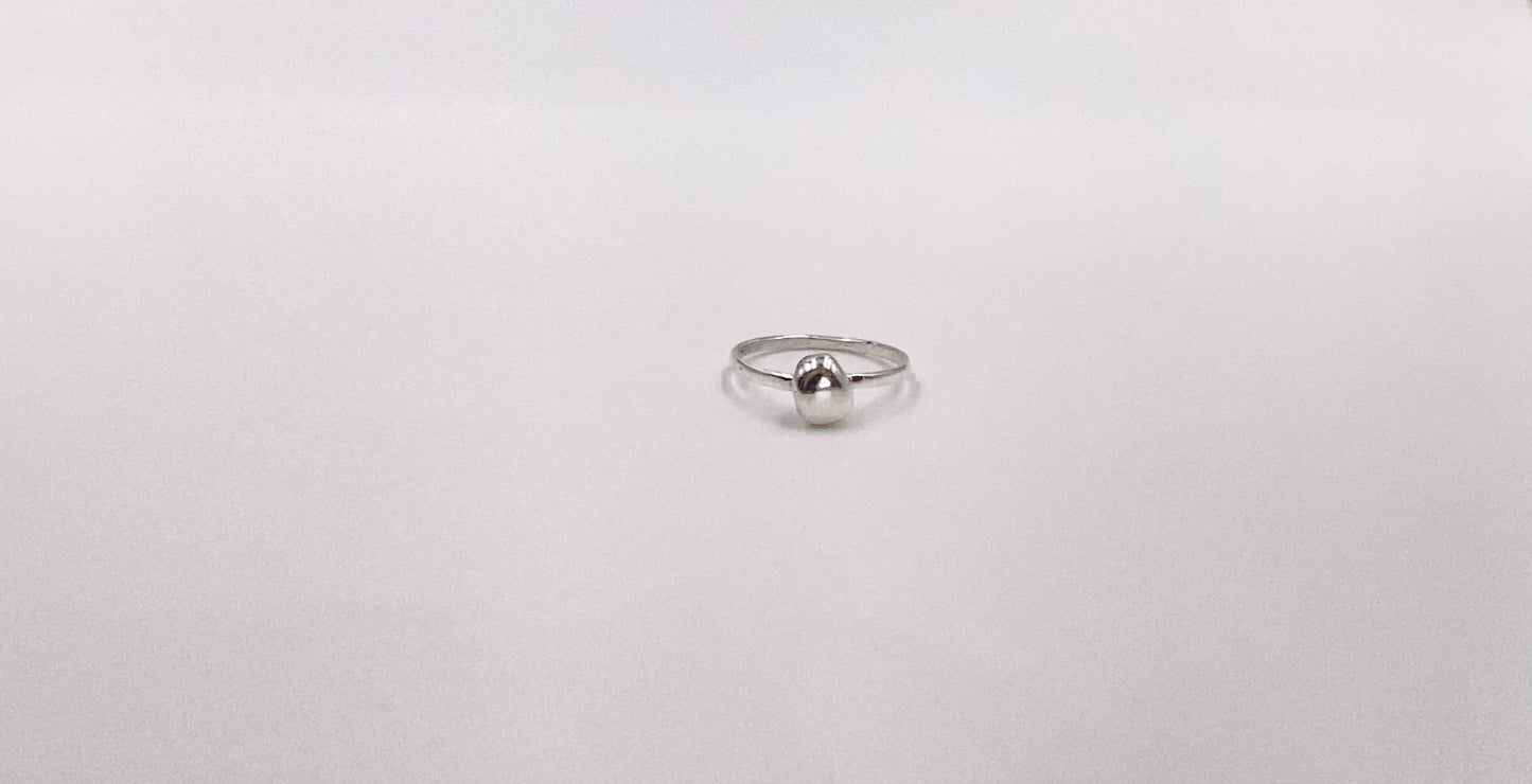 Organic sterling silver ring with large bump of silver resembling a raindrop as the focal, super simple straight band.