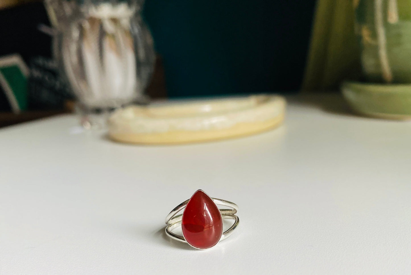 Split shank red pear shaped stone mounted with split shank sterling silver wire. 