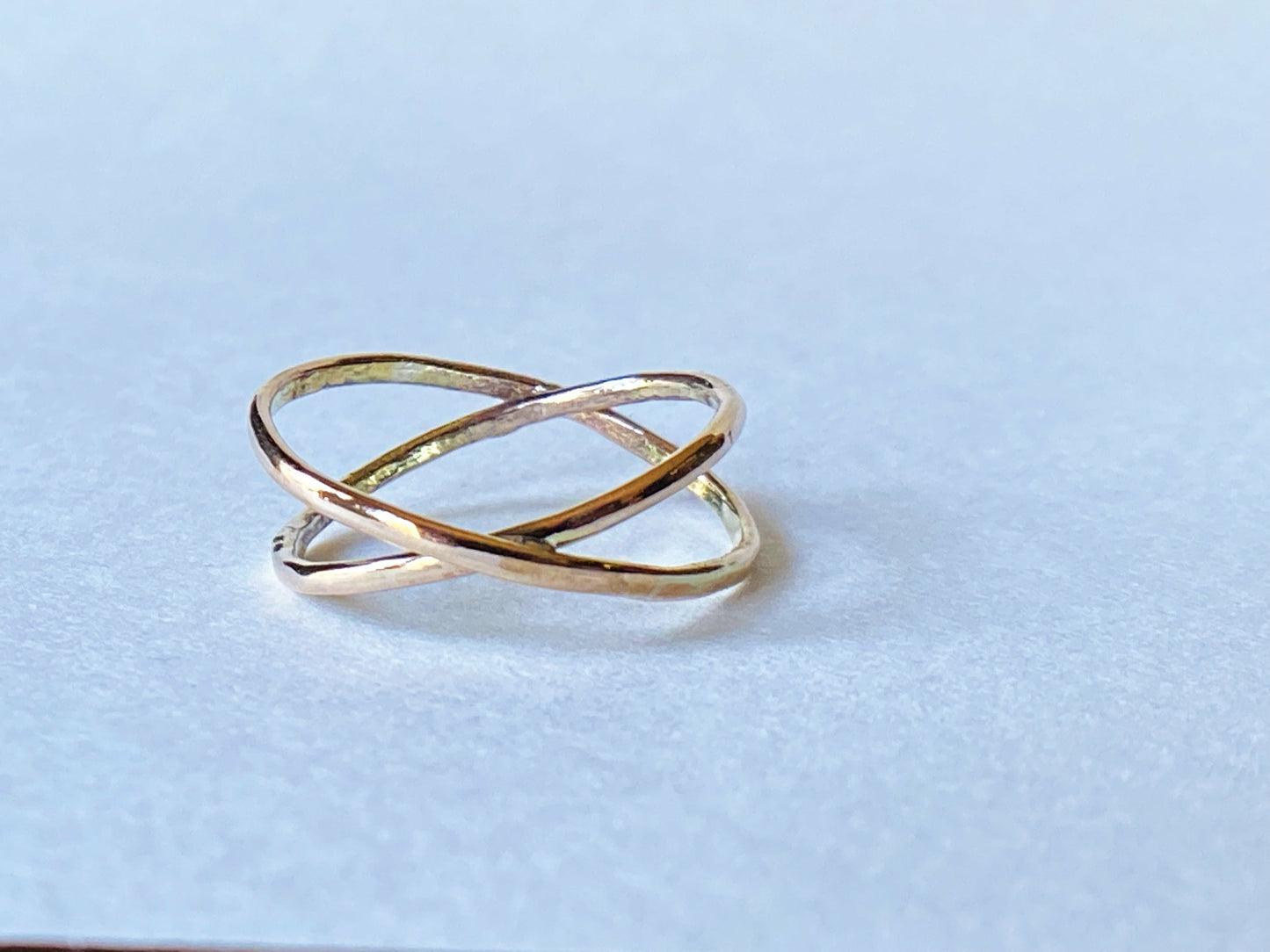 Two gold filled rings cross to make an x shape or a "twist" 