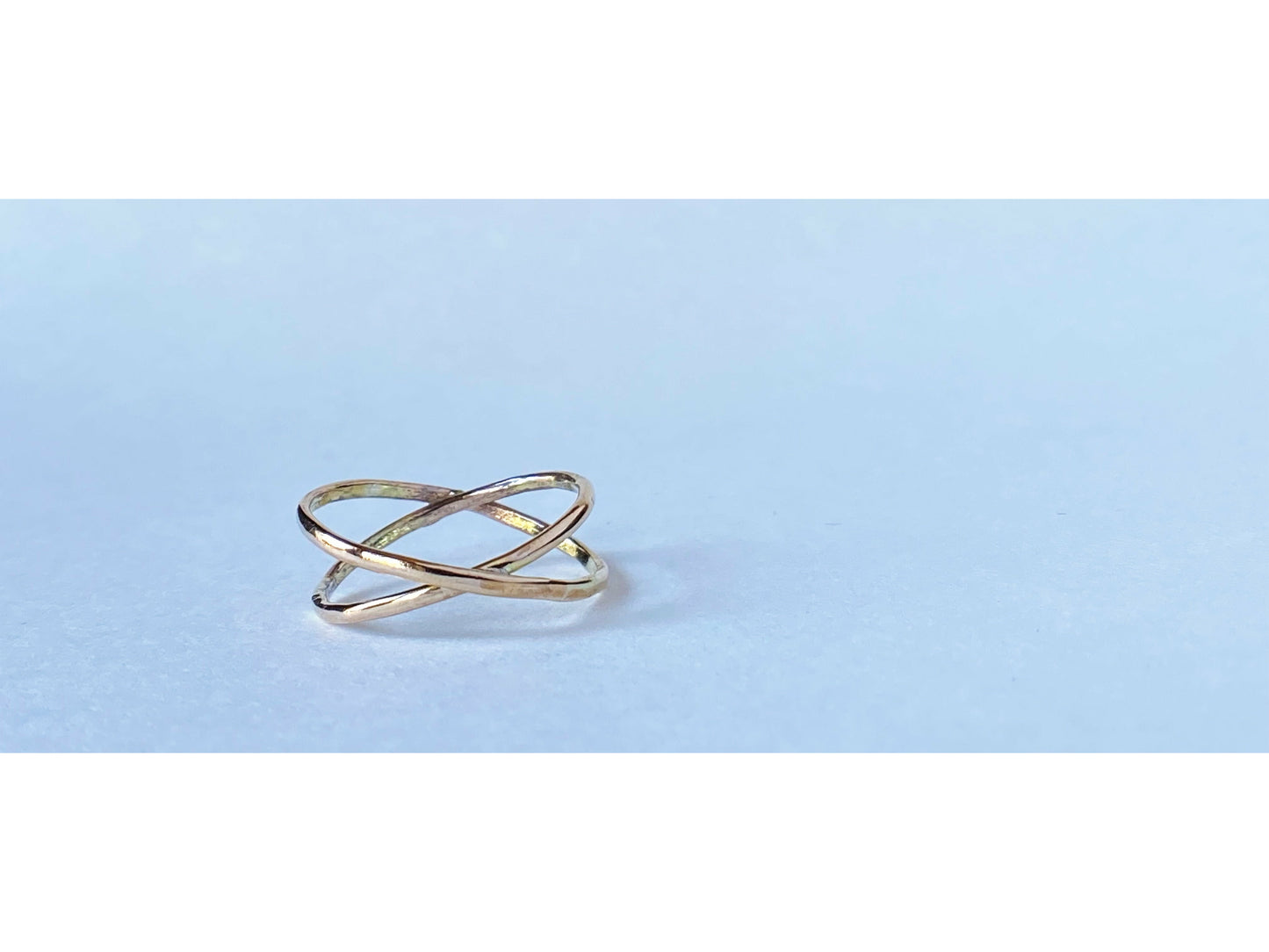 Two gold filled rings cross to make an x shape or a "twist" 