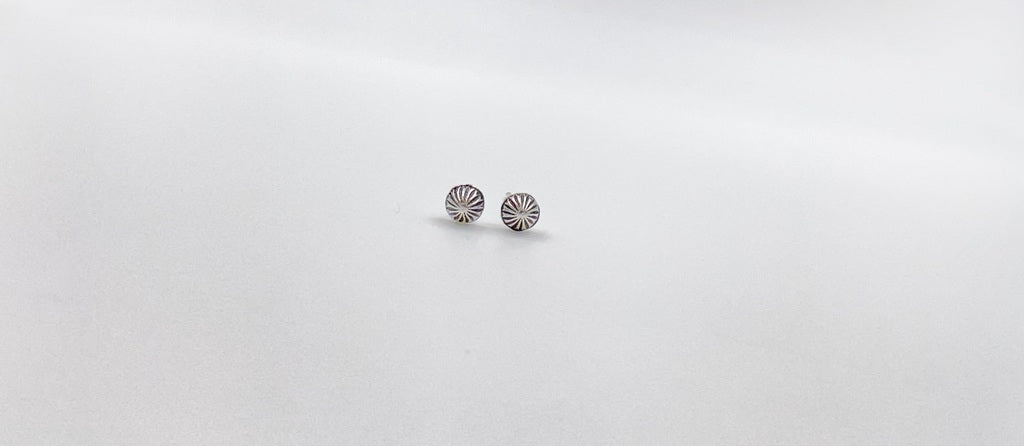 Small amethyst studs with closed back bezel. 