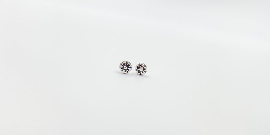 Small amethyst studs with closed back bezel. 